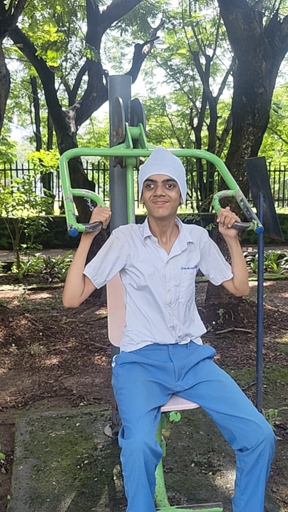 Student exercising on outdoor gym equipment